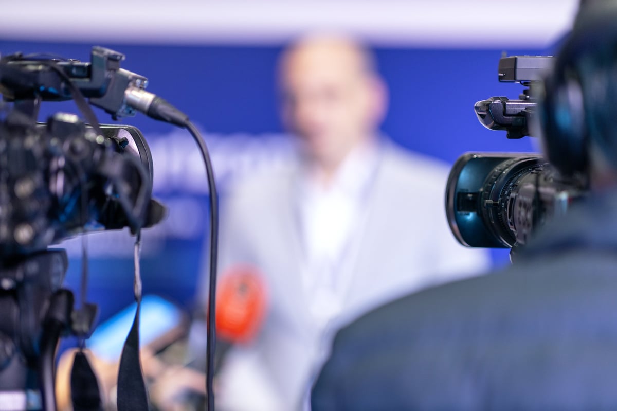 Professional video cameras capturing press conference